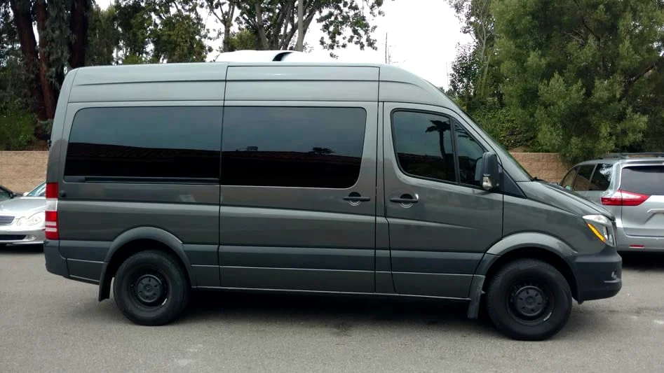 Olive green van with dark black tinted windows