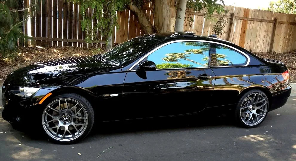 Black BMW sedan with chrome-like reflective tint