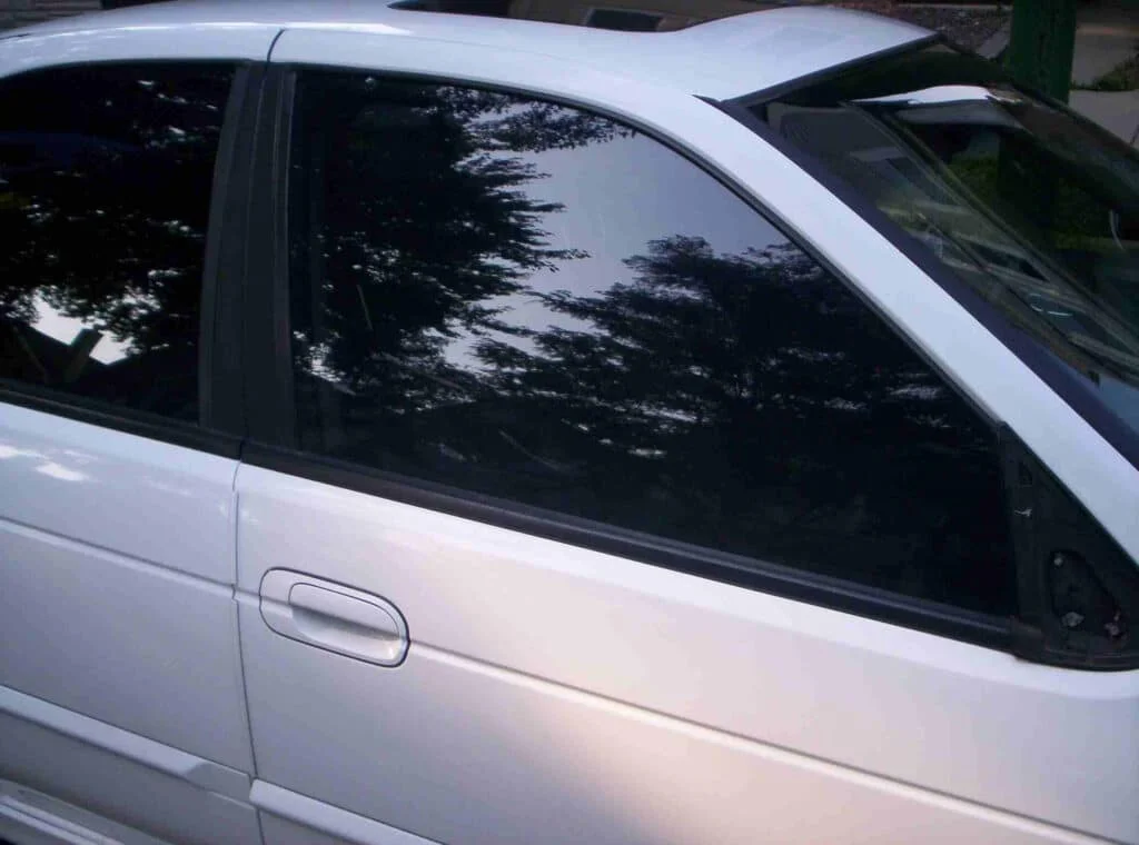 White sedan with dark black tinted windows in Nebraska