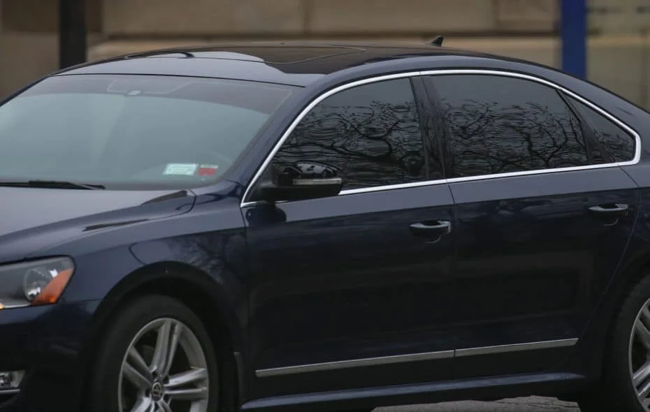 Dark blue VW sedan with reflective black windows