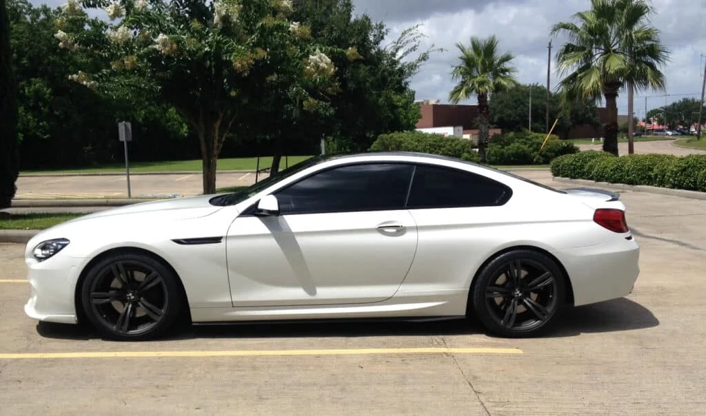 White sedan with dark black tinted windows