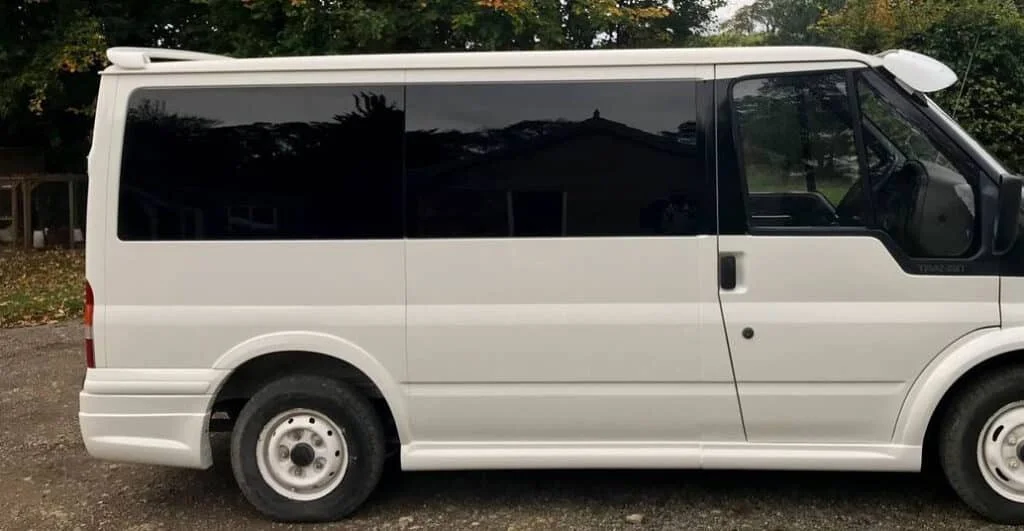White minivan with dark black tinted windows in Ohio