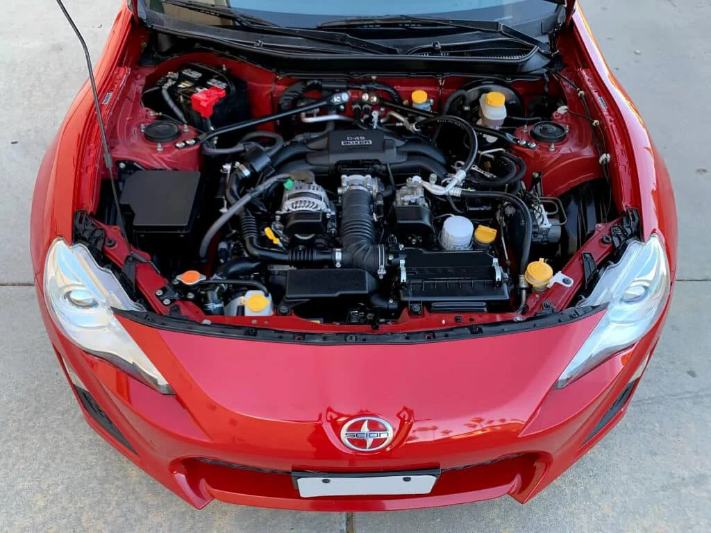 Engine bay of a red Scion FR-S