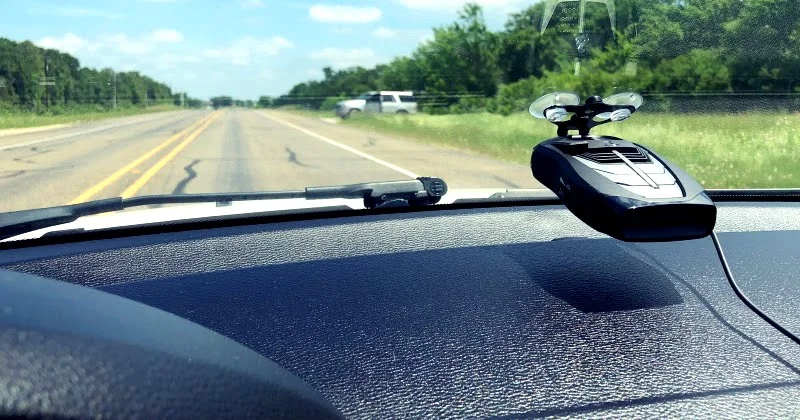 Radar detector mounted on the windshield of a car