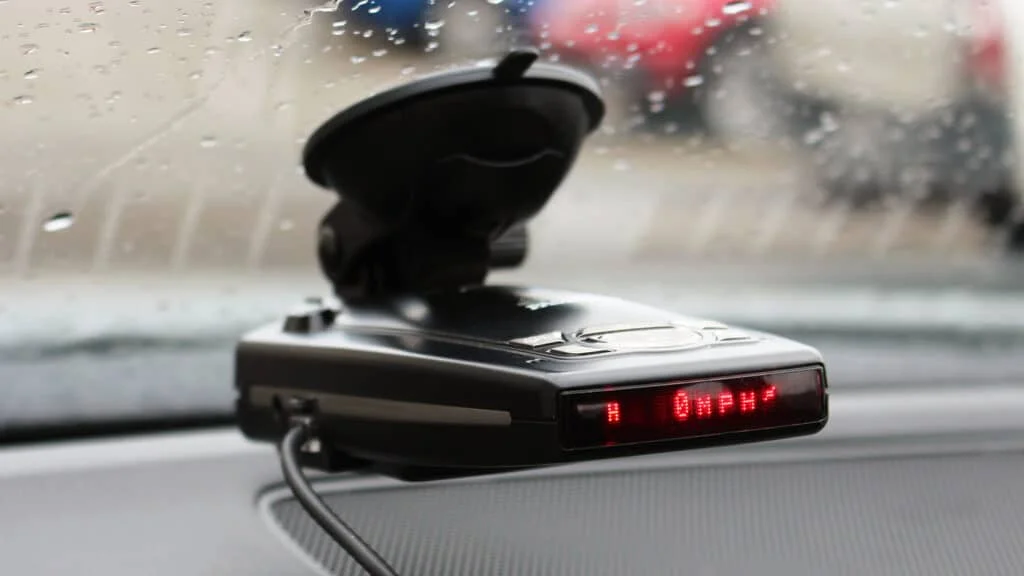 Radar detector mounted on the windshield of a car in NYC