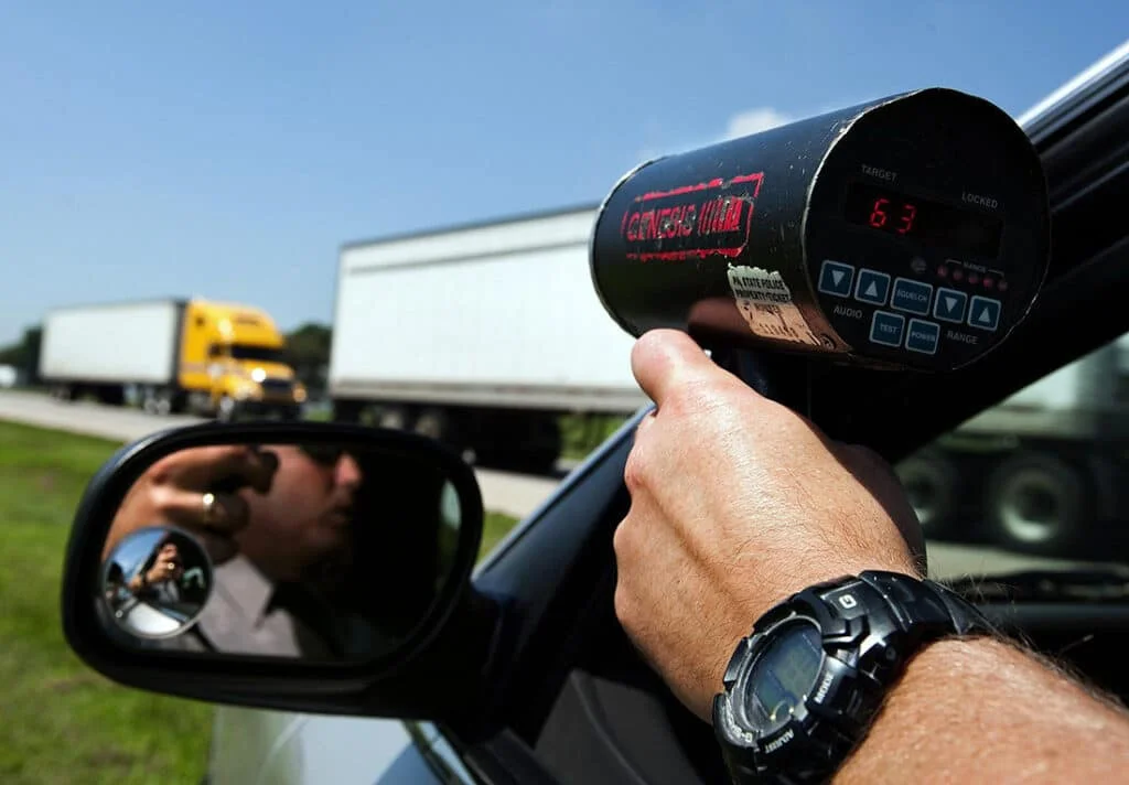 Alaska state trooper aiming radar detector at a commercial vehicle