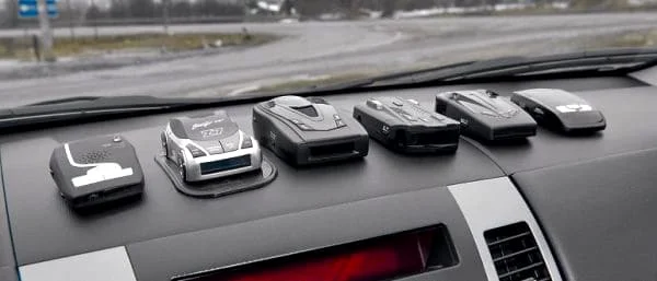 Multiple radar detectors placed on a car dashboard