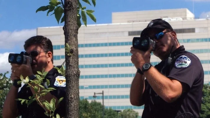 Police officers aiming radar guns