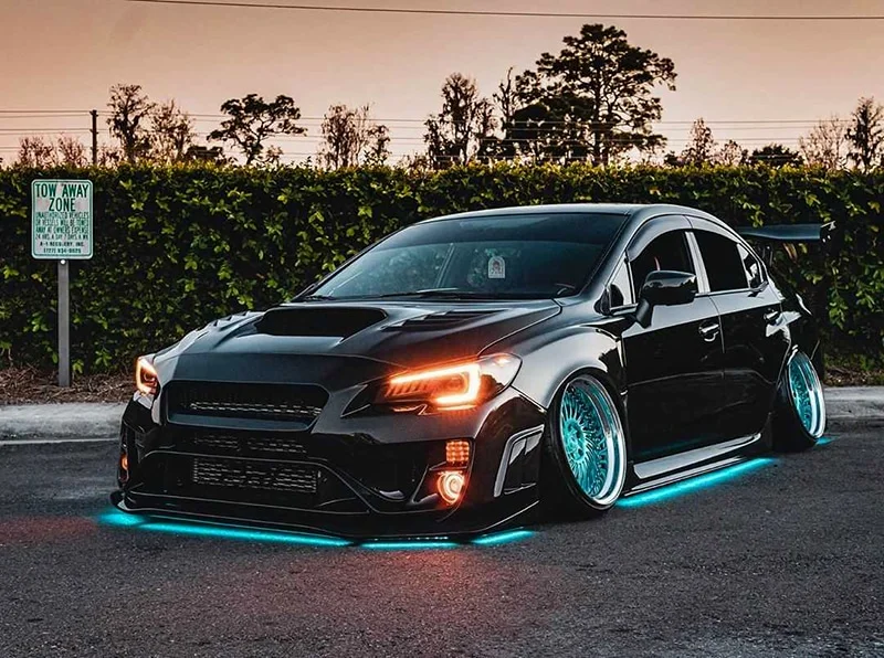 Black WRX with teal underglow