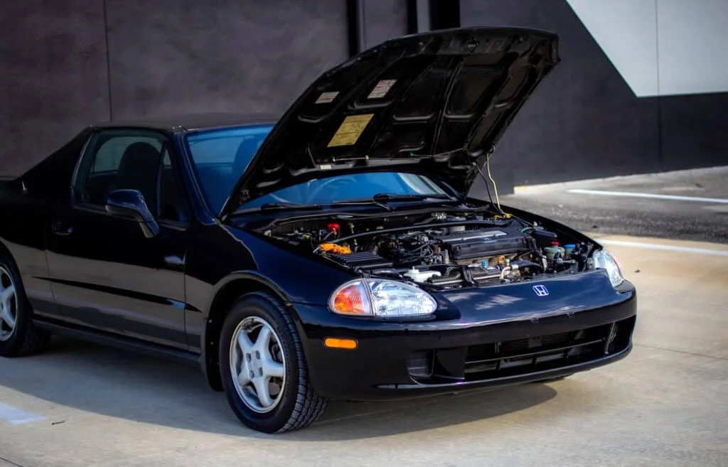 Black Honda del Sol with open hood