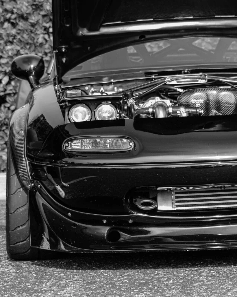 Modified NA MX5 with aftermarket headlights and intake