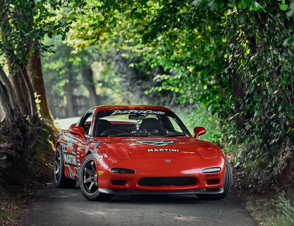 Red RX7 on a scenic mountain road