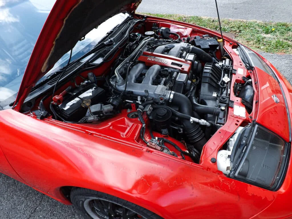 Red Nissan 300ZX with an open hood