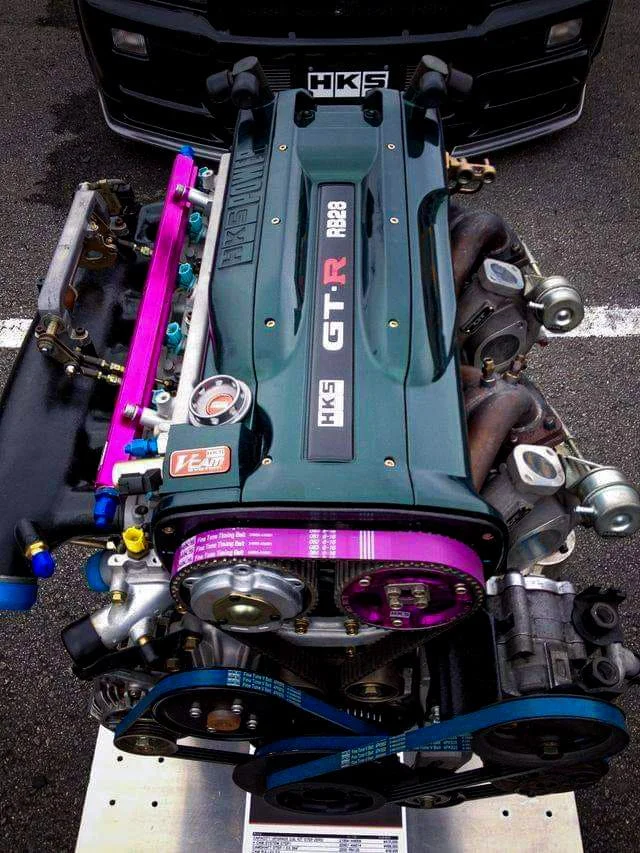 HKS RB28 engine with a magenta timing belt