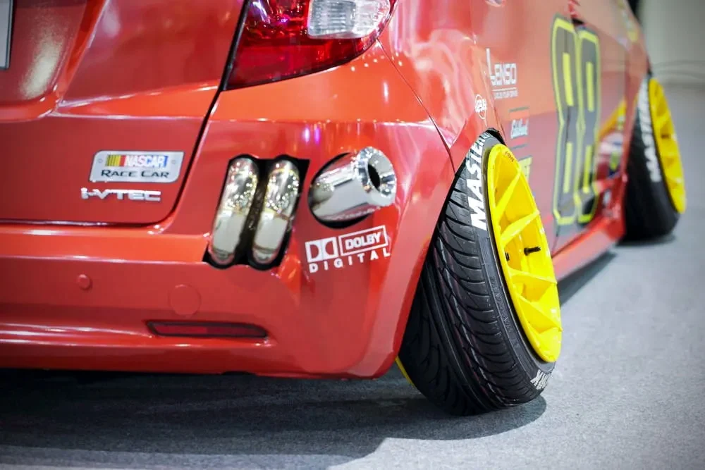 Red Honda Fit with yellow negative offset rims