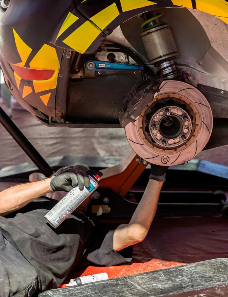 Technician upgrading the brakes on a car