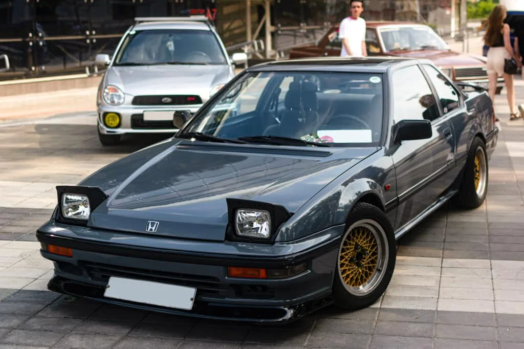 Dark green Honda Prelude with dished rims