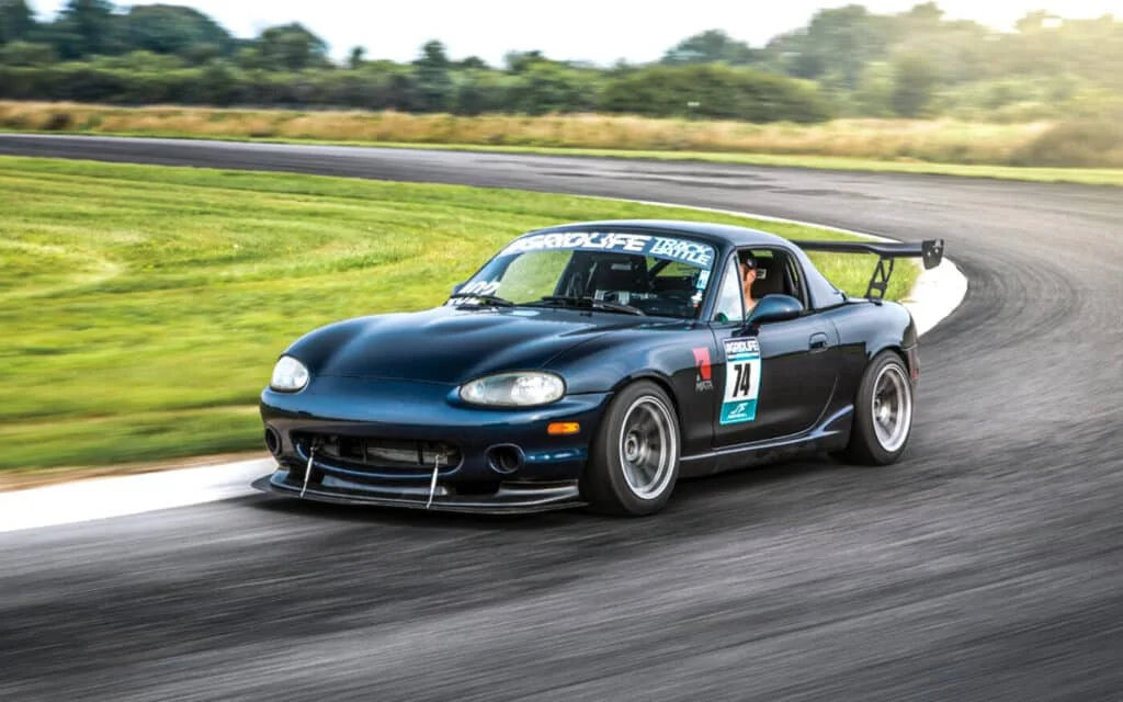 NB Miata accelerating out of a corner