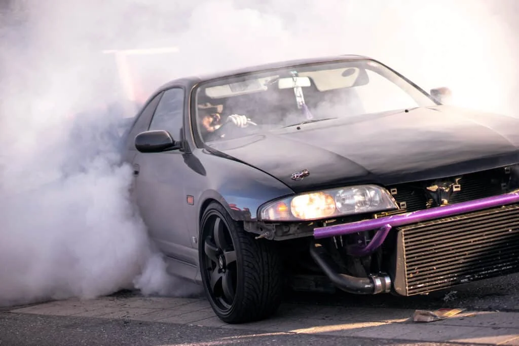 Black drift car with exposed intercooler and bash bar