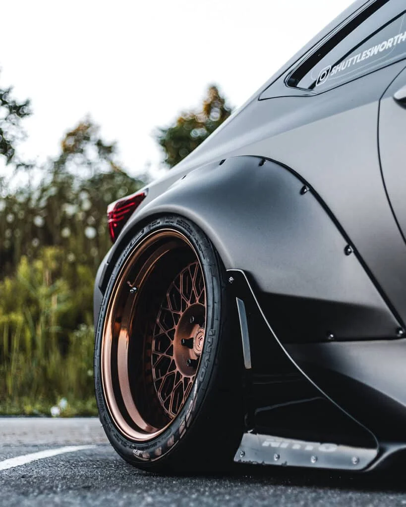 Rose-gold rims on a mate black widebody BRZ