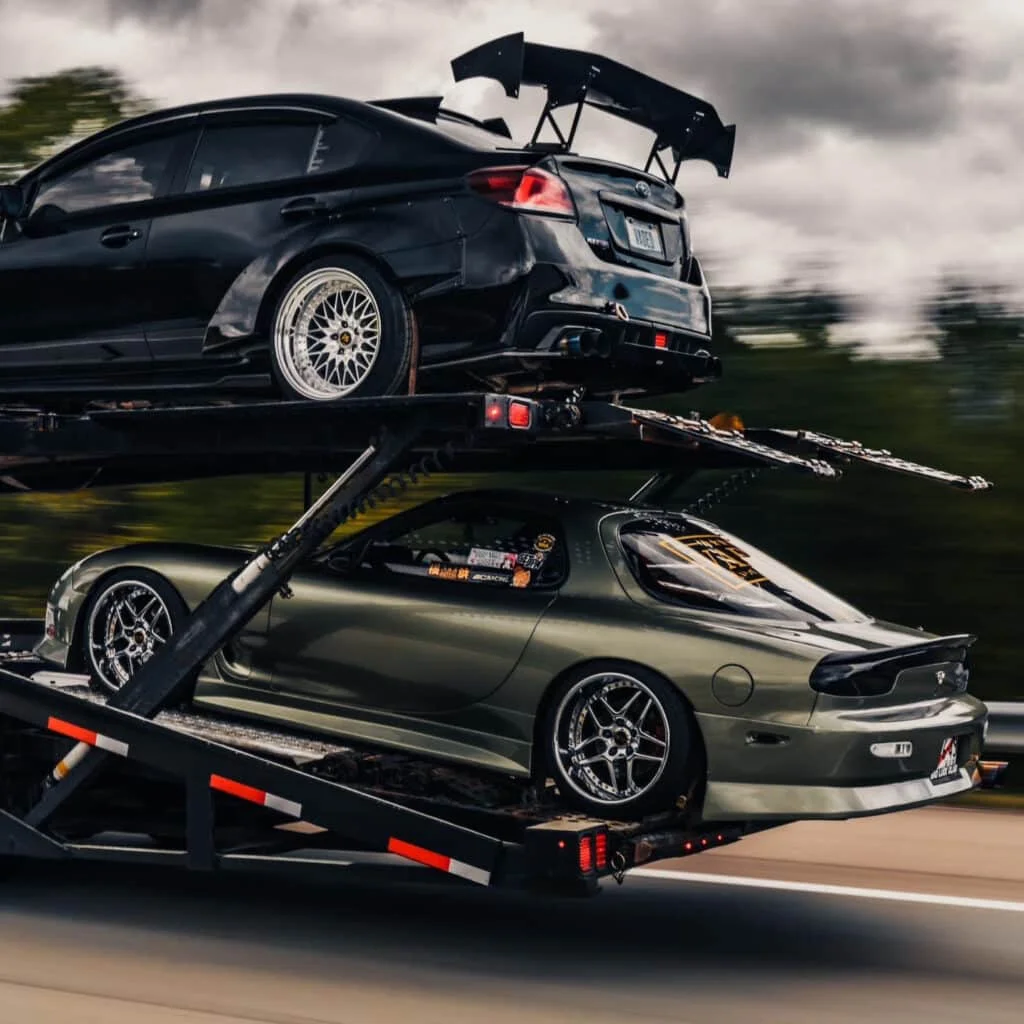 RX-7 and WRX being transported on a trailer