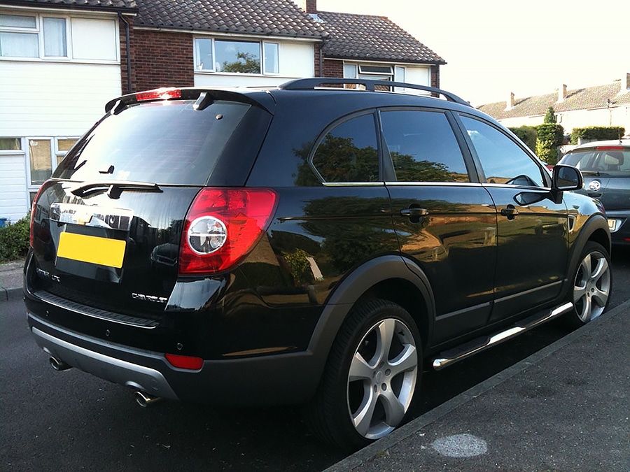 Black Chevrolet SUV with dark tinted windows