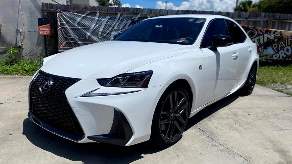 White Lexus sedan with black window tint