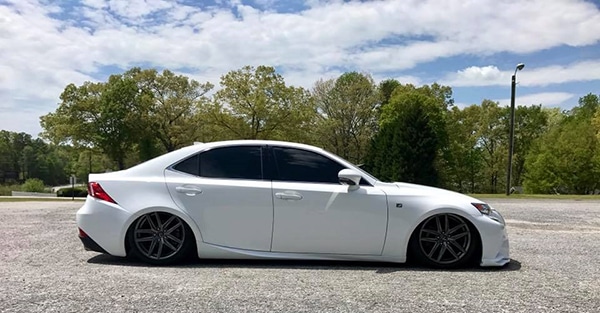 White sedan on air suspension with tinted windows