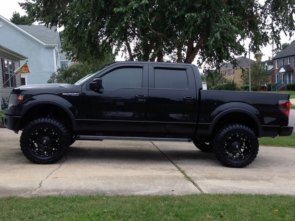 All-black Ford F150 with dark tinted windows.