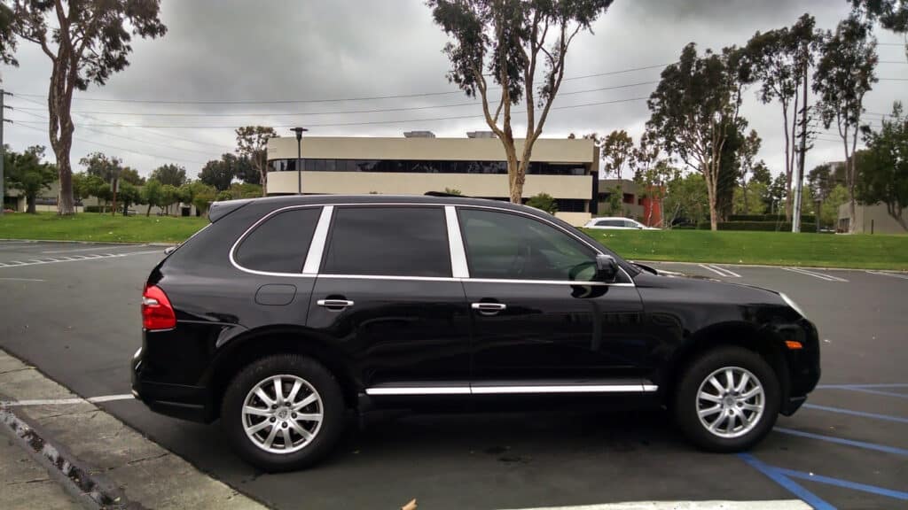 Black Porsche Cayenne with dark black tinted windows