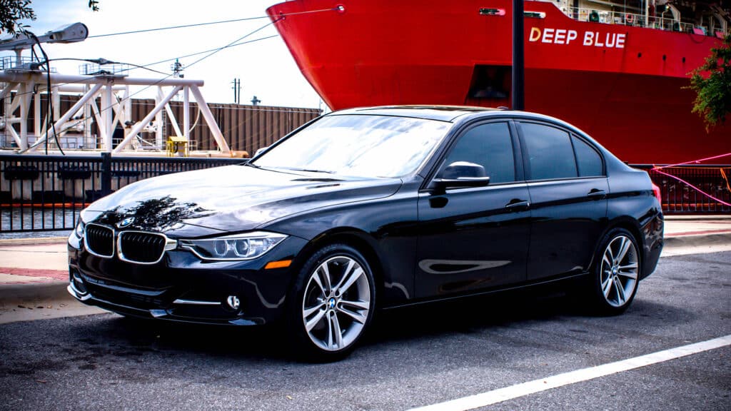 Black BMW sedan with dark tinted windows