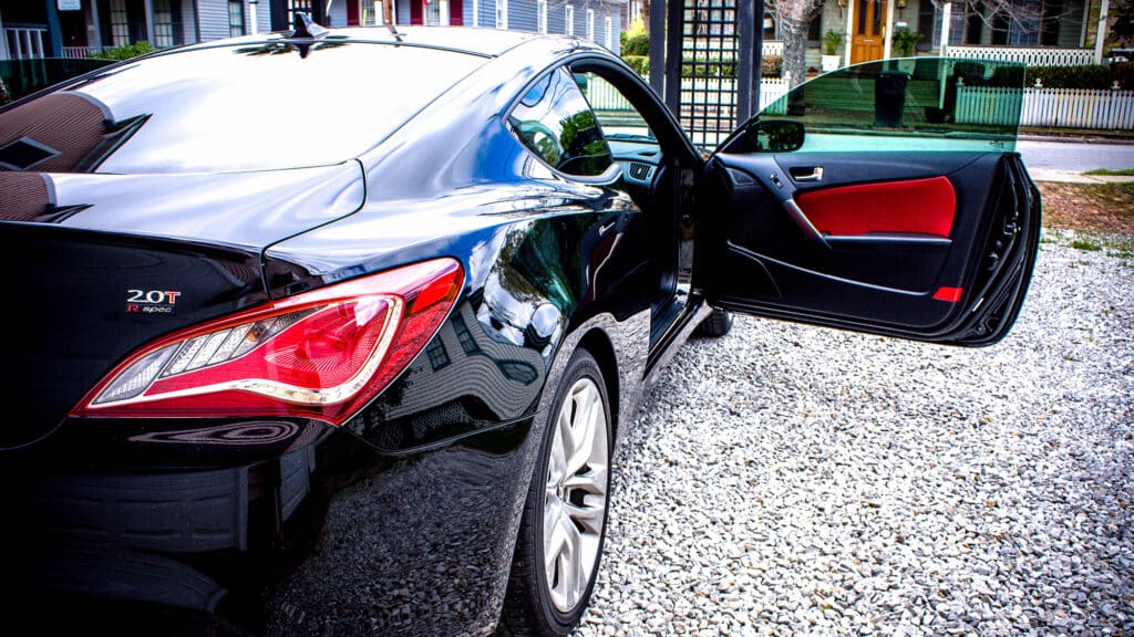 Black coupe with green tinted windows