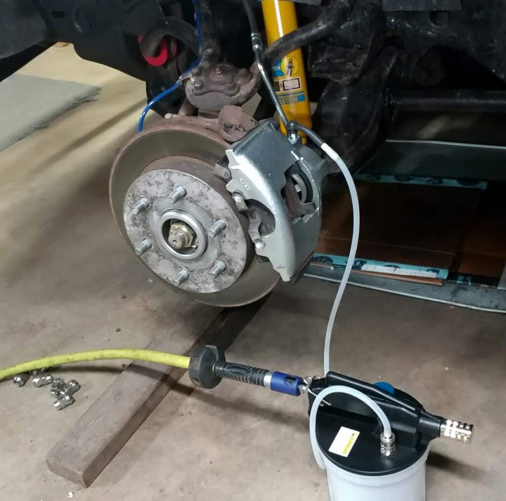 Air compressor operated brake bleeder