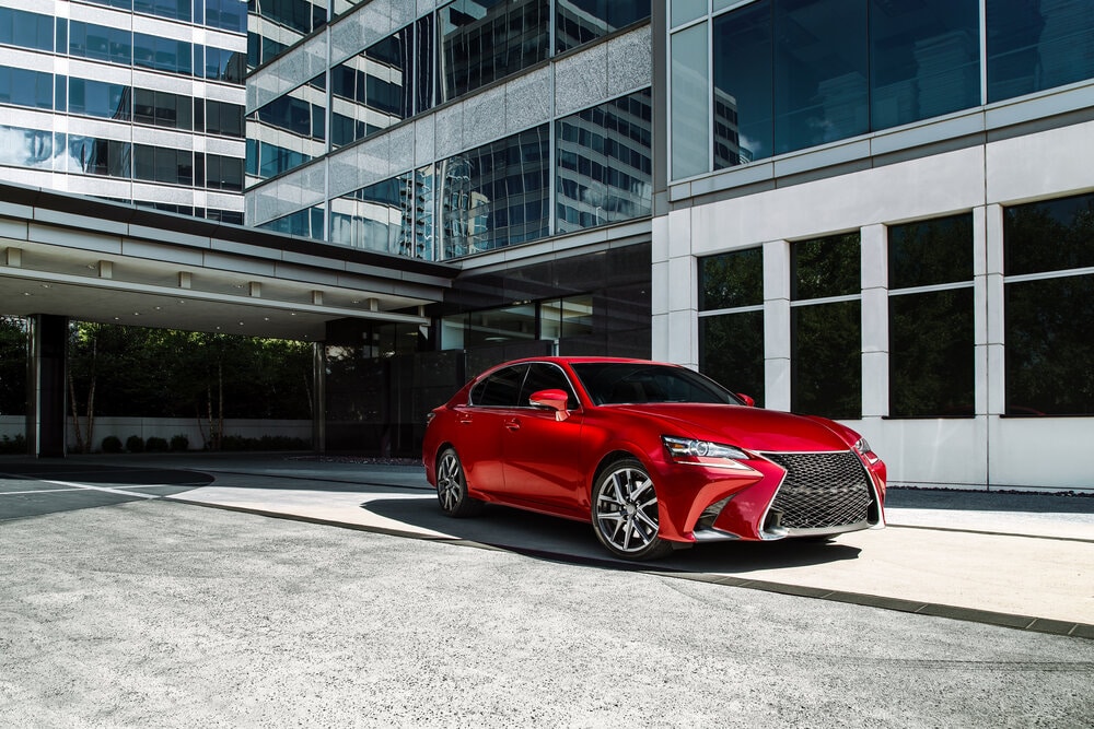Red Lexus sedan with black tinted windows