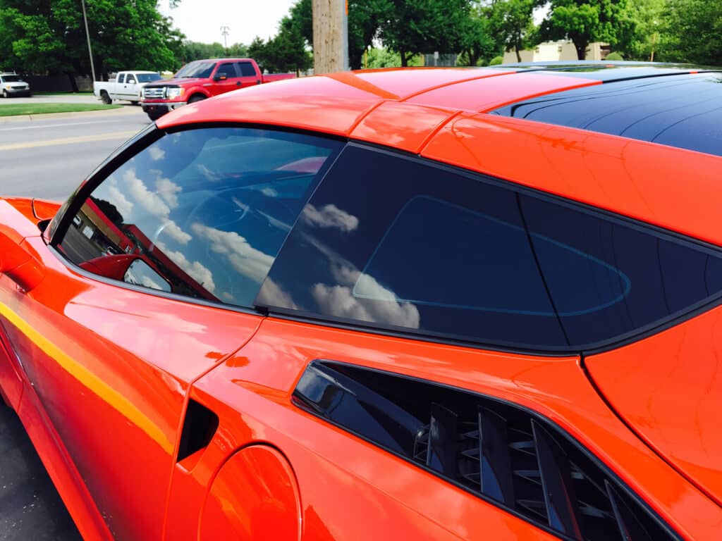 Reflective tinted windows on orange sports car