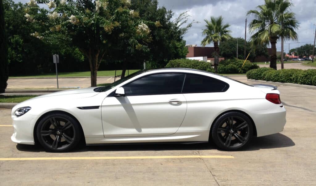 White sedan with dark black tinted windows