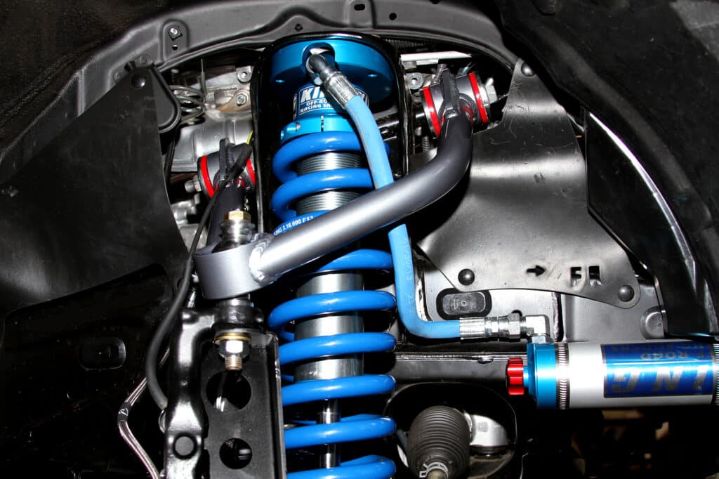 Aftermarket suspension with adjustable compression and rebound installed on a Tacoma