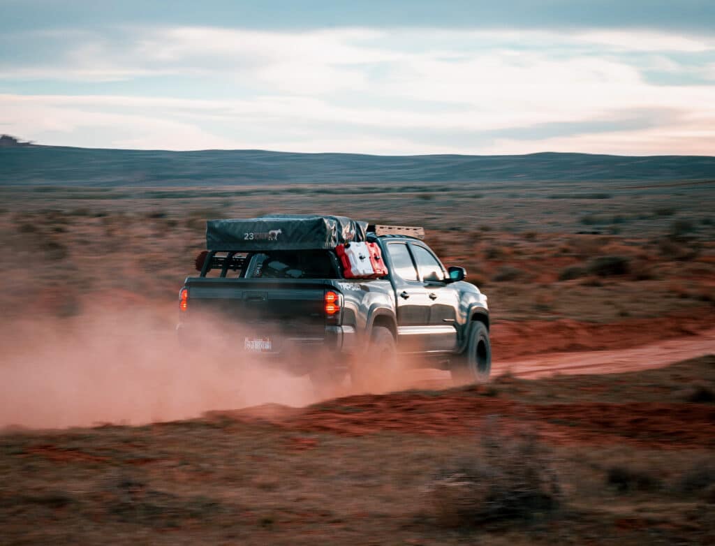 Lifted Tacoma on a dirt trail