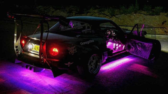 Tuner car with magenta neon lights