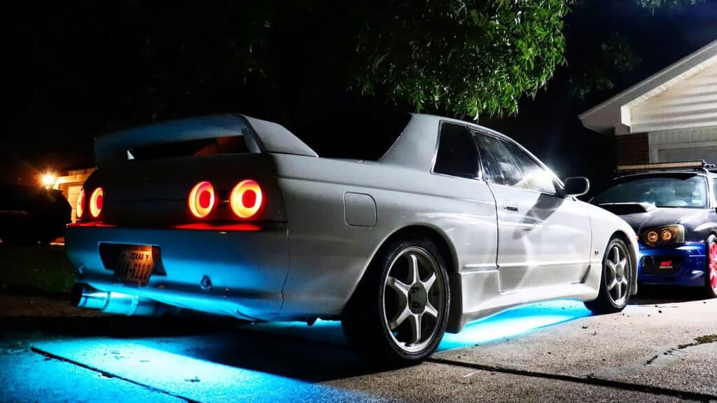 White R32 Skyline with aqua-blue ground effect lights