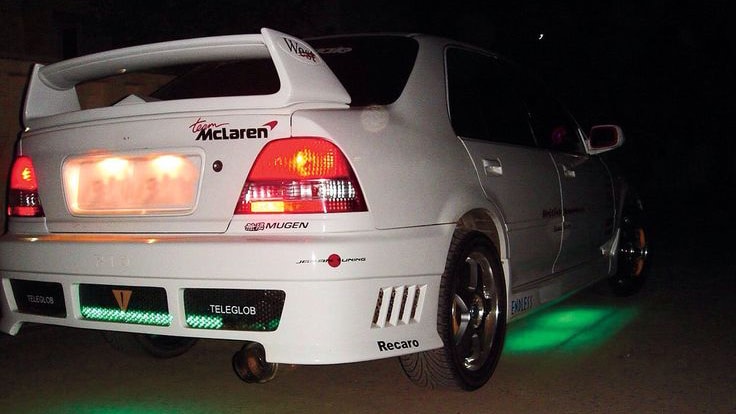 White Honda City with green LED underglow