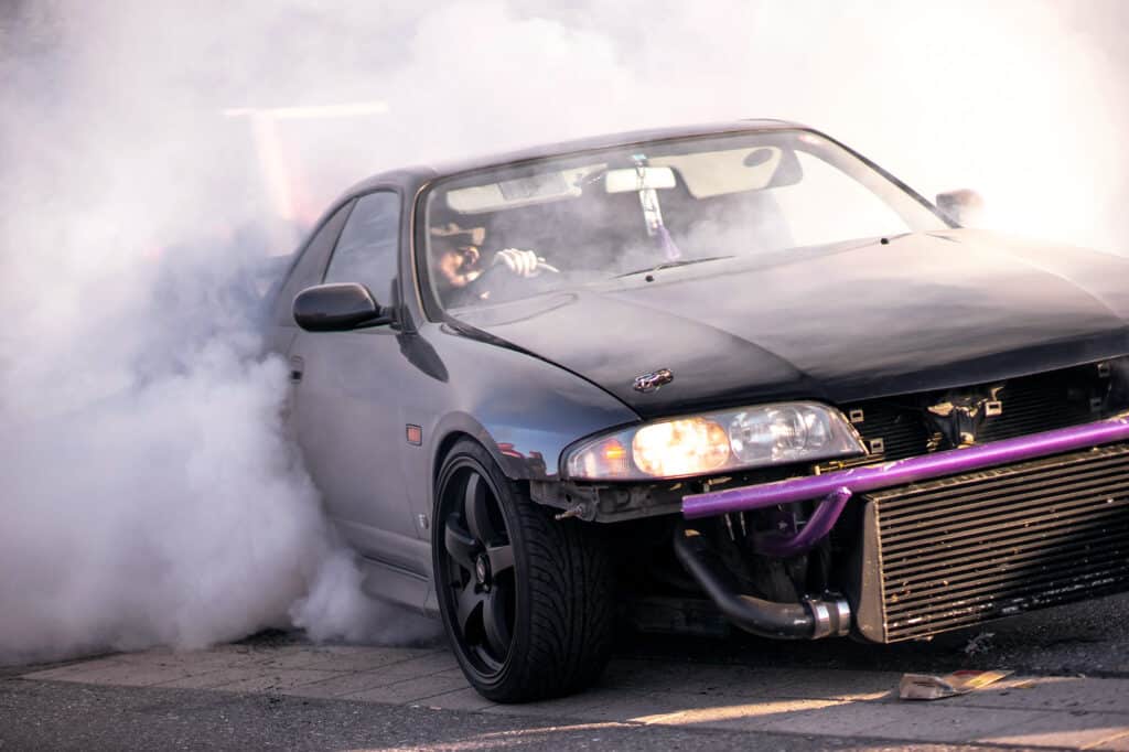 Black drift car with exposed intercooler and bash bar