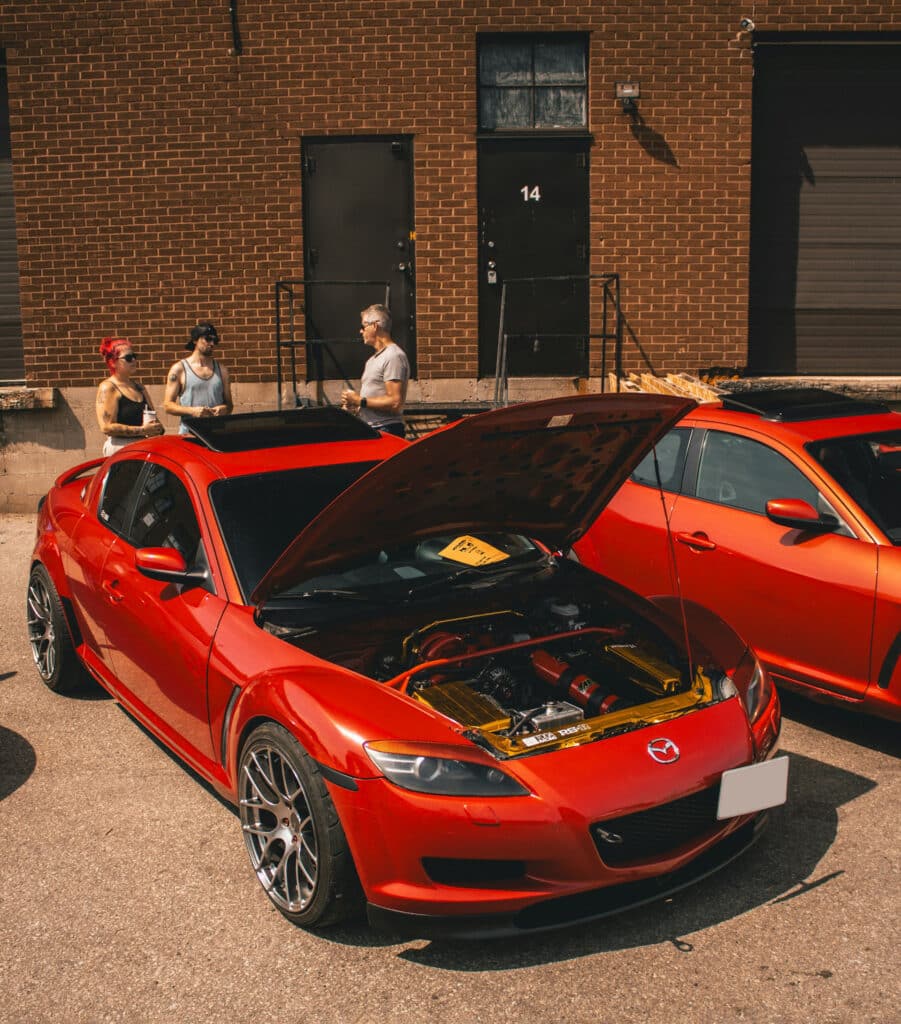 Red modified RX-8 with open hood